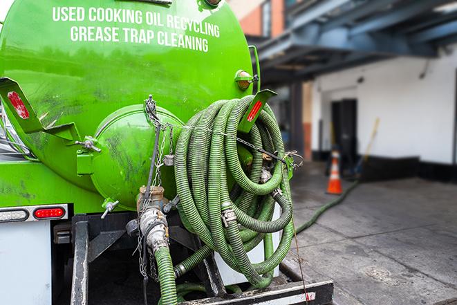 maintenance crew pumping grease trap at a fast food restaurant in Bingham Farms MI